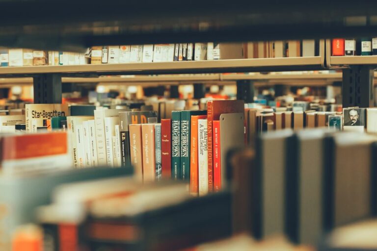 Bookshelves filled with diverse books capture a cozy library atmosphere indoors.